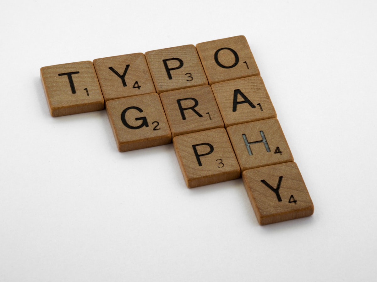 Brown wooden letterpress blocks on a white surface, representing the craft of writing and content